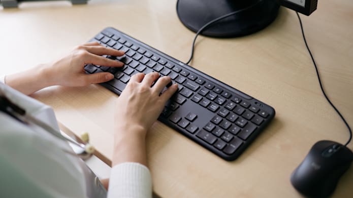 Women working on Signature Slim Wired Combo MK625 for Business
